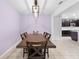 The dining room features an elegant pendant light and a dining table, set against a lavender wall at 15062 Hummingbird Rd, Weeki Wachee, FL 34614