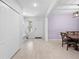 Bright entryway with a bench and storage, adjacent to a dining area with wood floors and a light purple wall at 15062 Hummingbird Rd, Weeki Wachee, FL 34614