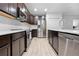 Bright kitchen features dark cabinets, stainless steel appliances, and a white countertop island at 15062 Hummingbird Rd, Weeki Wachee, FL 34614