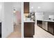 Modern kitchen with stainless steel appliances, white countertops, and dark cabinets at 15062 Hummingbird Rd, Weeki Wachee, FL 34614