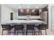 Kitchen island features a white countertop, dark cabinets, and seating for four at 15062 Hummingbird Rd, Weeki Wachee, FL 34614