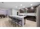 Open kitchen boasts an island with seating, stainless appliances, and is connected to the dining area at 15062 Hummingbird Rd, Weeki Wachee, FL 34614