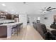 Bright open concept showcasing kitchen with seating, stainless steel appliances, and a living area with a ceiling fan at 15062 Hummingbird Rd, Weeki Wachee, FL 34614