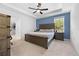 Well-lit main bedroom with blue accent wall, ceiling fan, and view of a closet at 15062 Hummingbird Rd, Weeki Wachee, FL 34614