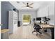 Bright office space with a ceiling fan, a workspace, and sliding glass door to the outside at 15062 Hummingbird Rd, Weeki Wachee, FL 34614
