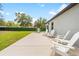 Outdoor patio features white Adirondack chairs and a grill, creating a relaxing outdoor living space at 15062 Hummingbird Rd, Weeki Wachee, FL 34614