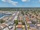 Panoramic aerial perspective of a well-planned residential area featuring homes with diverse roof colors, landscaping, and street layout at 1747 Wood Brook St, Tarpon Springs, FL 34689