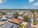 Picturesque aerial shot showcases the community's layout, including homes, landscaping, and a tranquil lake at 1747 Wood Brook St, Tarpon Springs, FL 34689