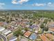 Picturesque aerial view of a suburban neighborhood with lush trees, various home styles, and a glimpse of the wider community at 1747 Wood Brook St, Tarpon Springs, FL 34689