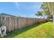 Fenced backyard provides privacy and security with green grass; ready for pets and outdoor enjoyment at 1747 Wood Brook St, Tarpon Springs, FL 34689