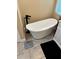 Modern bathroom featuring a standalone tub, stylish fixtures, and attractive tile flooring at 1747 Wood Brook St, Tarpon Springs, FL 34689