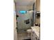 Bathroom with glass shower, stylish tile, and white vanity with double sinks at 1747 Wood Brook St, Tarpon Springs, FL 34689