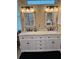Elegant bathroom featuring a double vanity with marble countertop and rustic-style mirrors at 1747 Wood Brook St, Tarpon Springs, FL 34689