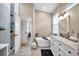 Stylish bathroom features a soaking tub, glass shower, vanity with white countertops, and neutral tiling at 1747 Wood Brook St, Tarpon Springs, FL 34689