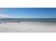 Serene beach view with white sand and calm ocean waters under a clear sky at 1747 Wood Brook St, Tarpon Springs, FL 34689