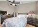 Comfortable bedroom features wood floors, dark furniture, and soothing neutral colors at 1747 Wood Brook St, Tarpon Springs, FL 34689