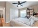 Bright bedroom with a ceiling fan, closet, shelves, and natural light at 1747 Wood Brook St, Tarpon Springs, FL 34689
