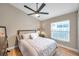 Bedroom with neutral colors, hardwood floors, and a ceiling fan at 1747 Wood Brook St, Tarpon Springs, FL 34689