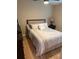 Comfortable bedroom featuring a ceiling fan, with a view of hardwood floors and a nightstand at 1747 Wood Brook St, Tarpon Springs, FL 34689