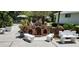 Charming courtyard featuring decorative benches, flowerbeds, and a miniature brick structure at 1747 Wood Brook St, Tarpon Springs, FL 34689