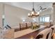 Dining room overlooking a relaxing living area with a ceiling fan at 1747 Wood Brook St, Tarpon Springs, FL 34689
