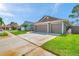 Lovely single-Gathering home with a three-car garage, green lawn, and well-maintained exterior at 1747 Wood Brook St, Tarpon Springs, FL 34689