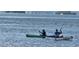 Two people kayak across the water on a clear day with distant islands at 1747 Wood Brook St, Tarpon Springs, FL 34689