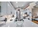 Bright white kitchen boasts a large island, updated appliances, and stylish backsplash at 1747 Wood Brook St, Tarpon Springs, FL 34689