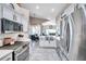 Bright, modern kitchen features stainless steel appliances and a view into the stylish dining area at 1747 Wood Brook St, Tarpon Springs, FL 34689