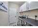 Modern laundry room with white cabinets and LG washer and dryer at 1747 Wood Brook St, Tarpon Springs, FL 34689