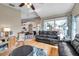 Open concept living room with hardwood floors, a leather sofa and access to patio at 1747 Wood Brook St, Tarpon Springs, FL 34689
