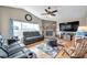 Spacious living room with hardwood floors, a stone fireplace, and large windows at 1747 Wood Brook St, Tarpon Springs, FL 34689