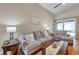 Bright living room with neutral furniture, hardwood floors, and a sliding glass door to the patio at 1747 Wood Brook St, Tarpon Springs, FL 34689