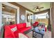 Inviting screened patio featuring cozy seating, ceiling fan, and sliding glass doors for indoor-outdoor living at 1747 Wood Brook St, Tarpon Springs, FL 34689