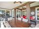 Covered patio with dining and lounge area, perfect for outdoor entertaining with ceiling fans and sliding doors at 1747 Wood Brook St, Tarpon Springs, FL 34689