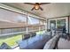 Relaxing screened patio with ceiling fan, outdoor grill, and comfortable seating area for year-round enjoyment at 1747 Wood Brook St, Tarpon Springs, FL 34689