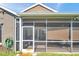 Enclosed screened porch featuring durable mesh and a door leading to the outdoor space at 1747 Wood Brook St, Tarpon Springs, FL 34689