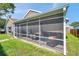 A spacious screened porch, ideal for outdoor living and entertaining at 1747 Wood Brook St, Tarpon Springs, FL 34689