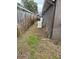 Side yard with grass lawn and a wooden fence at 1747 Wood Brook St, Tarpon Springs, FL 34689