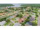 Aerial view of the neighborhood showcases lush landscaping and scenic lake views at 1831 Stable Trl, Palm Harbor, FL 34685