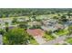 Aerial view highlights the neighborhood's well-manicured lawns, mature trees, and community layout at 1831 Stable Trl, Palm Harbor, FL 34685