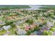 Aerial view of a residential community near a lake with mature trees at 1831 Stable Trl, Palm Harbor, FL 34685