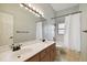 Bathroom featuring double sinks, tile floors, and shower with curtain at 1831 Stable Trl, Palm Harbor, FL 34685