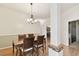 Cozy dining room with laminate floors, modern lighting and view of kitchen at 1831 Stable Trl, Palm Harbor, FL 34685