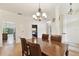 Bright dining room with laminate floors, modern lighting and view of kitchen and pool at 1831 Stable Trl, Palm Harbor, FL 34685