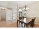 Open concept dining room and foyer with neutral paint colors and laminate floors at 1831 Stable Trl, Palm Harbor, FL 34685