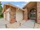 Exterior of home with arched entrance, stone details and concrete walkway at 1831 Stable Trl, Palm Harbor, FL 34685