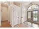 Foyer with laminate floors, view of dining room and hallway to bedrooms at 1831 Stable Trl, Palm Harbor, FL 34685