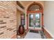 Close up of front entrance with double doors, planters and arched window at 1831 Stable Trl, Palm Harbor, FL 34685