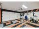 Spacious garage featuring black, orange, and checker-patterned floor with an overhead garage door at 1831 Stable Trl, Palm Harbor, FL 34685